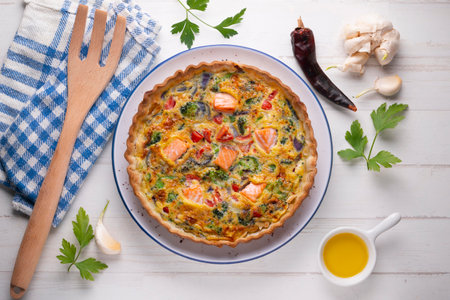 Traditional salmon quiche with broccoli and vegetables.の写真素材