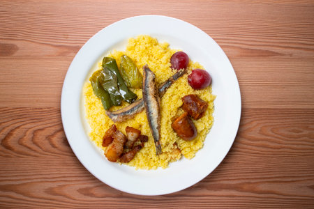 Migas with chorizo. Traditional Spanish tapa from Andalucia. Christmas food served on an elegant table.の写真素材