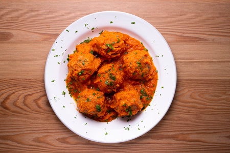 Meat meatballs with tomato sauce and vegetables. Traditional Spanish tapa recipe.の写真素材