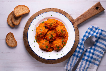 Meat meatballs with tomato sauce and vegetables. Traditional Spanish tapa recipe.の写真素材