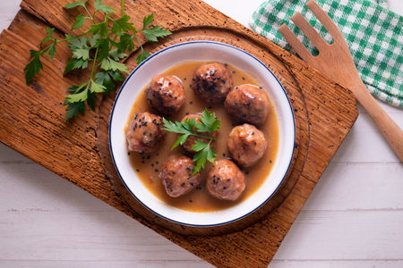 Meat meatballs with tomato sauce and vegetables. Traditional Spanish tapa recipe.の写真素材