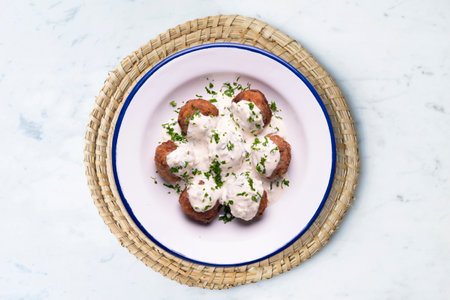Pork meatballs with Greek tzatziki sauce with cucumber and yogurt.の写真素材