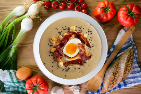 Smoked aubergine cream with crispy Iberian ham and boiled egg.の写真素材