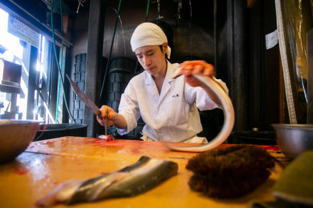 Narita, Japan; 1st October 2023: Japanese chef preparing and cleaning an eel. Grilled smoked eel is...