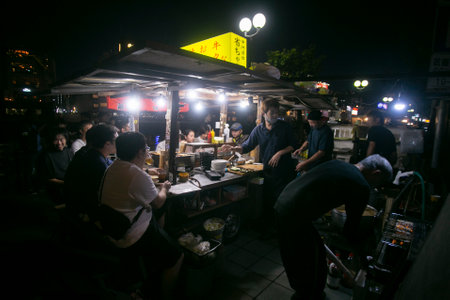 Fukuoka, Japan; 1st October 2023: People eating and drinking in a Yatai in Hakata Bay. A Yatai is a small, mobile food stall in Japan typically selling ramen or other food.のeditorial素材
