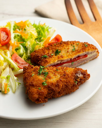 Cachopo is a Spanish dish that consists of two breaded beef fillets stuffed with cheese and serrano...