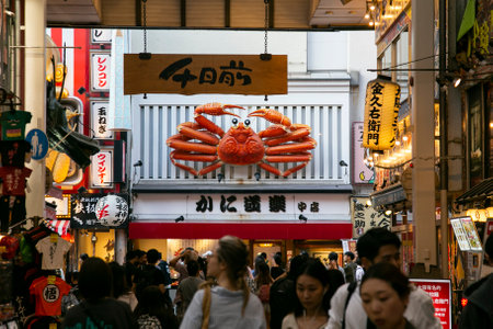 Osaka, Japan; 20th October 2023: Restaurants and tourists in Dotonbori streets full of street food stands and nightlife.のeditorial素材