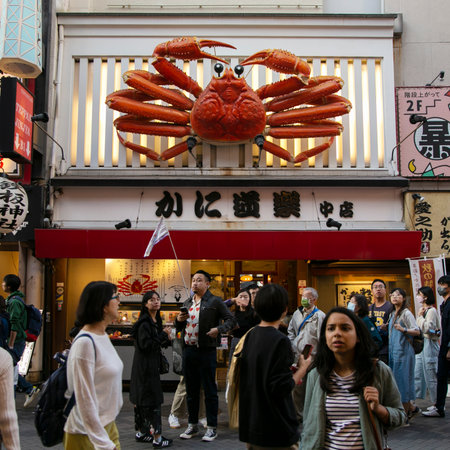 Osaka, Japan; 20th October 2023: Restaurants and tourists in Dotonbori streets full of street food stands and nightlife.のeditorial素材