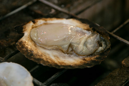 Seafood shell and fish cooked on a grill at the Osaka fish market in Japan.の写真素材
