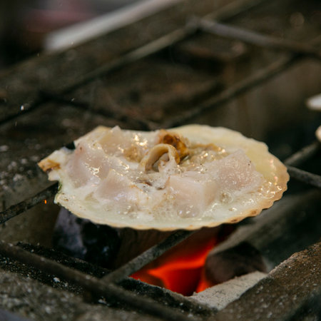Seafood shell and fish cooked on a grill at the Osaka fish market in Japan.の写真素材