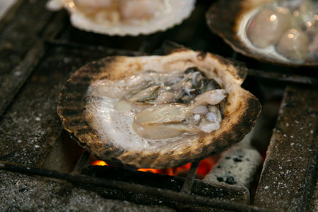 Seafood shell and fish cooked on a grill at the Osaka fish market in Japan.の写真素材