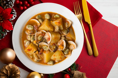 Clam stew with potatoes and beans. Traditional Spanish recipe on a Christmas table.の写真素材