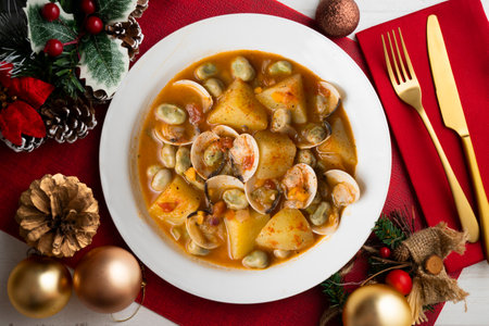 Clam stew with potatoes and beans. Traditional Spanish recipe on a Christmas table.の写真素材