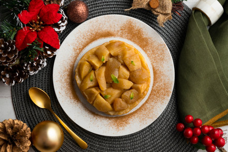 Delicious tarte tatin with apples from an overhead perspective. Food on a Christmas table.