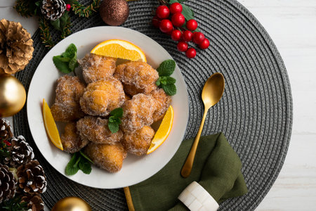 Delicious traditional Spanish fritters. Table decorated with Christmas decorations.の写真素材