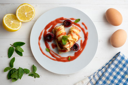 Delicious rolls with crepe dough filled with cherry sauce.の写真素材