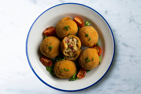 Spanish Tapa croquettes made with bechamel sauce and stuffed with octopus and potato. Top view...