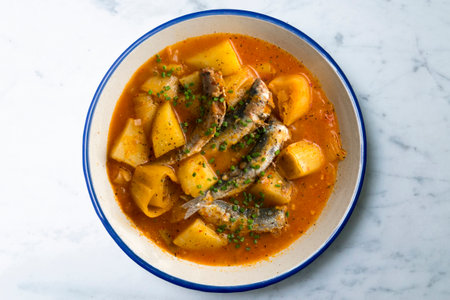 Sardine stew with potatoes and leeks. Top view table with decorations.の写真素材
