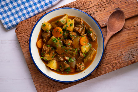 Beef stew with potatoes and artichoke. Top view table with decoration.の写真素材