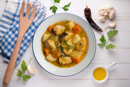 Hake stew with potatoes and carrots. Top view table with decorations.の写真素材