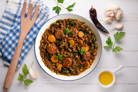 Lentil stew with chorizo, spinach and carrot. Top view table with decorations.の写真素材