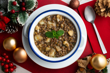 Lentil stew with potatoes, traditional Spanish tapa. Top view table with Christmas decorations.の写真素材