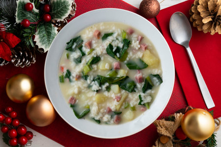Rice, ham and spinach soup, traditional tapa. Top view table with Christmas decorations.の写真素材