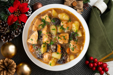 Turkey stew with prunes and potatoes. Top view table with Christmas decoration.の写真素材