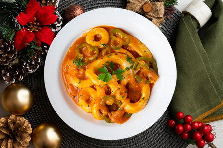 Squid stew with potatoes, artichokes and vegetables. Top view table.の写真素材