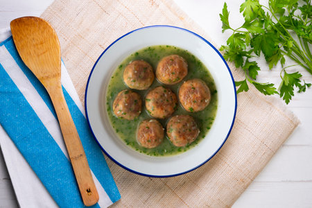 Fish meatballs with green parsley sauce. Top view table with decoration.の写真素材