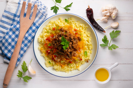 Couscous salad with vegetables and minced meat. Top view table with decoration.の写真素材