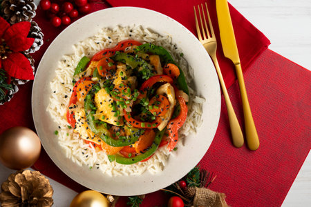 Wok of chicken strips with peppers and rice. Top view table.