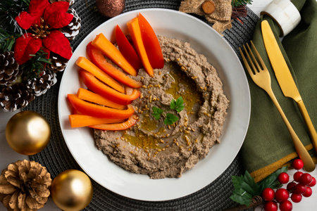 Lentil hummus with carrot and pepper crudites. Top view table with Christmas decorations.