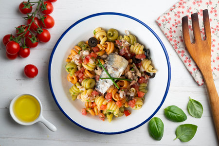 Italian pasta with sardines and black olives. Top view table with decorations.の写真素材