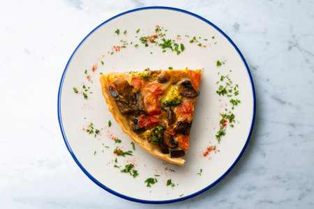 Piece of roasted vegetarian vegetable quiche. Top view table with decorations.の写真素材