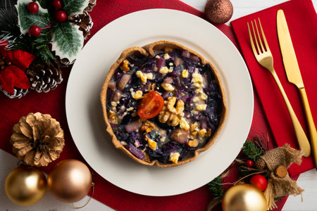 Individual vegan quiche with vegetables and red cabbage. Top view table with christmas decoration.の写真素材