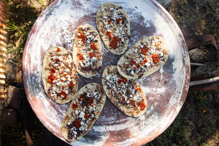 Memela or mamelita is a Mexican oval tortilla, handmade with corn dough. They are thick and covered...