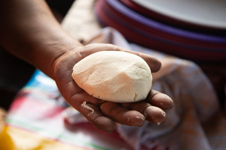 Preparing corn tortillas by hand for traditional quesadillas in the Oaxaca region of Mexico.の写真素材