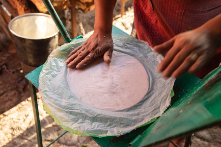 Preparing corn tortillas by hand for traditional quesadillas in the Oaxaca region of Mexico.の写真素材