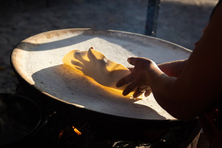 Preparing corn tortillas by hand for traditional quesadillas in the Oaxaca region of Mexico.の写真素材