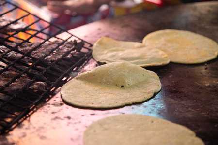 Cooking memelas in Oaxaca Central de Abastos Market with local cheese, pork jerky, eggs and hot sauce.の写真素材