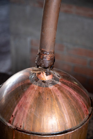 Mezcal is fermented and distilled in copper still tanks in artisanal palenques in the Oaxaca region...