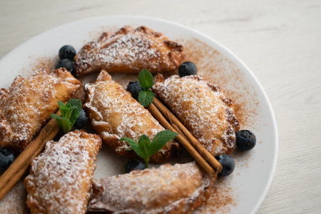 Sweet fried empanadas filled with fruit and blueberries.