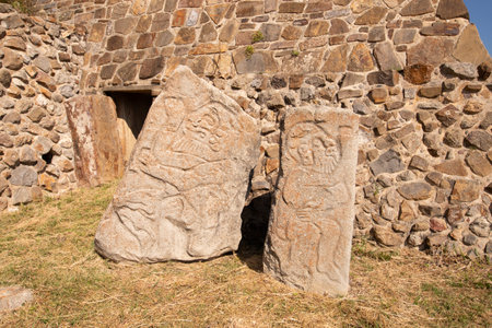 Building and wall of the dancers at the ancient archaeological ruins of Monte Alban in the Oaxaca...