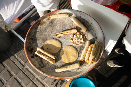 A woman cooking tortillas, flautillas and Mexican memelas on a comal on a street in Oaxaca.の写真素材