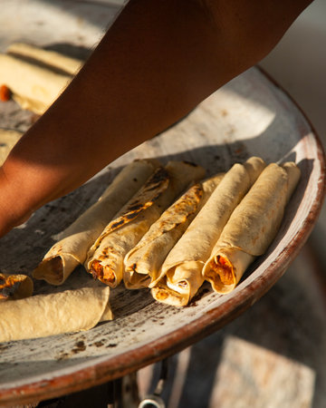 A woman cooking tortillas, flautillas and Mexican memelas on a comal on a street in Oaxaca.の写真素材