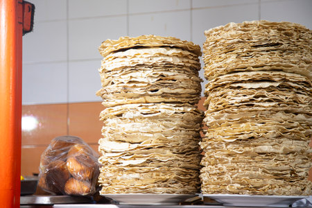 Tlayuda is a thin, crispy tortilla topped with black beans, beef jerky, tomato and avocado. It is a traditional Mexican food from Oaxaca.の写真素材