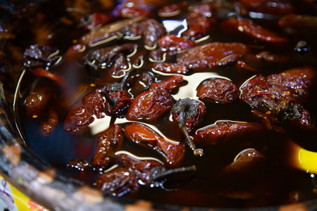 Traditional food stall with moles, nopales, and chiles in clay pots at the 5 de Mayo market in Puebla, Mexico.の写真素材