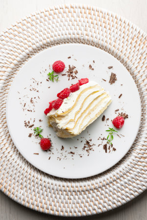 Crepe and cream cake decorated with lime and raspberries. Top view table with christmas decorations.の写真素材