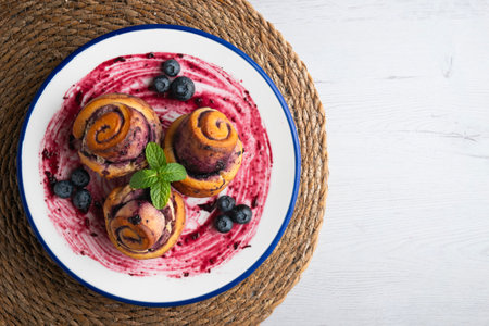 Blueberry and cinnamon rolls. Top view table with christmas decorations.の写真素材